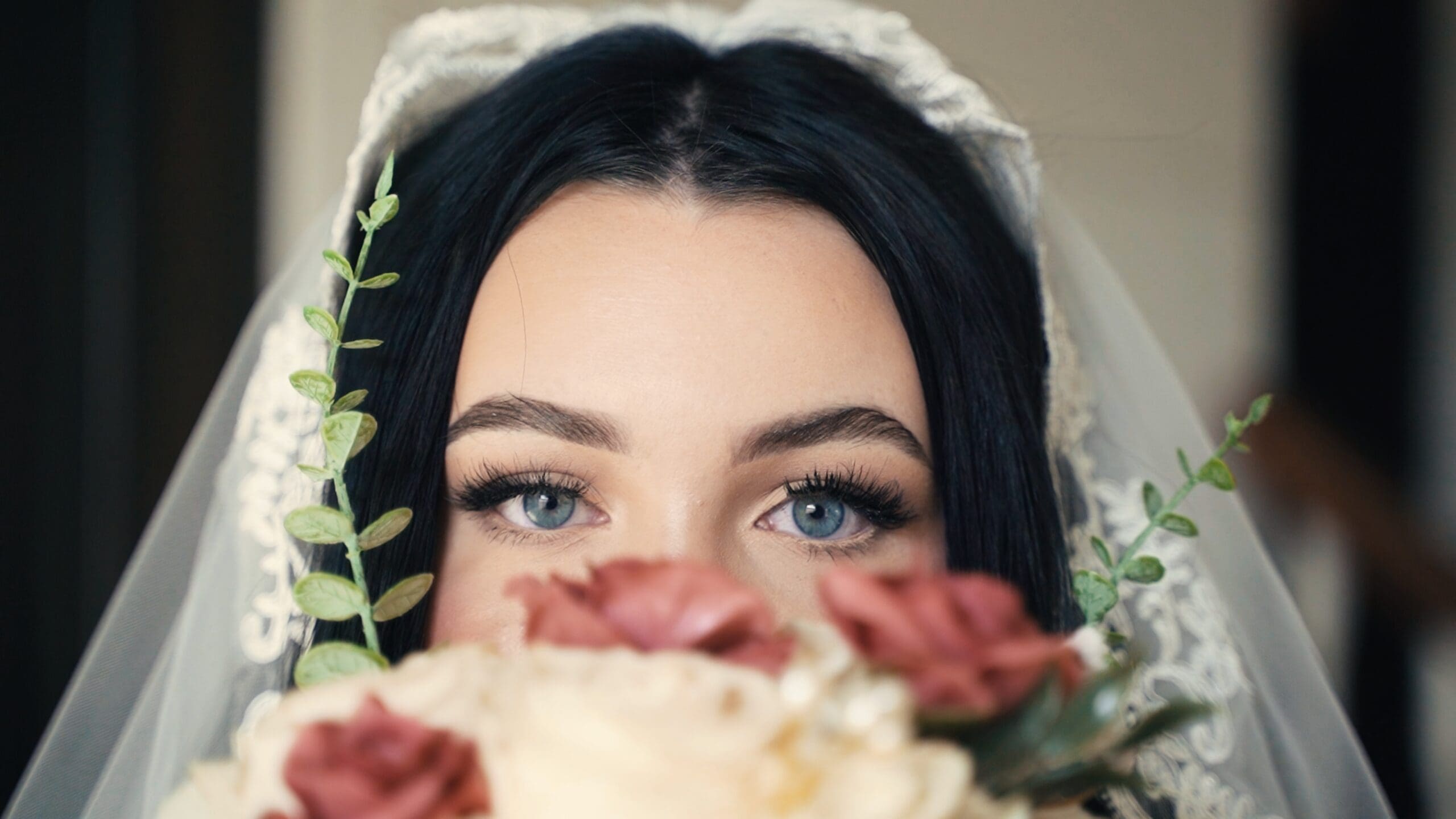 Close-up bridal portrait with bouquet and veil during a Missouri barn wedding.
