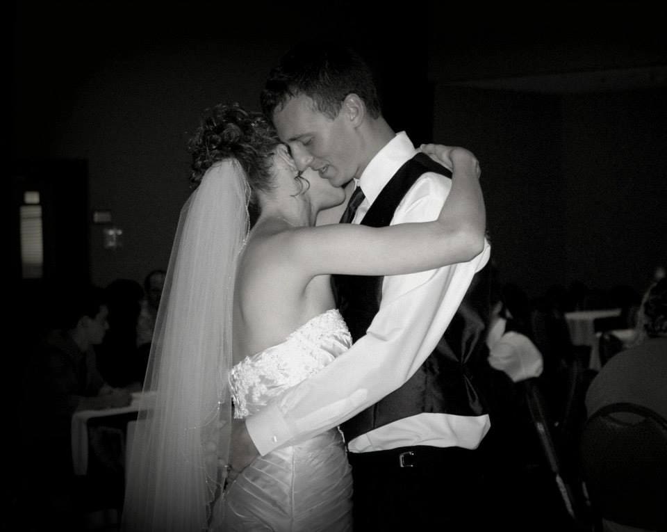 Bride and groom sharing their first dance at a Missouri wedding reception in a timeless black and white photo