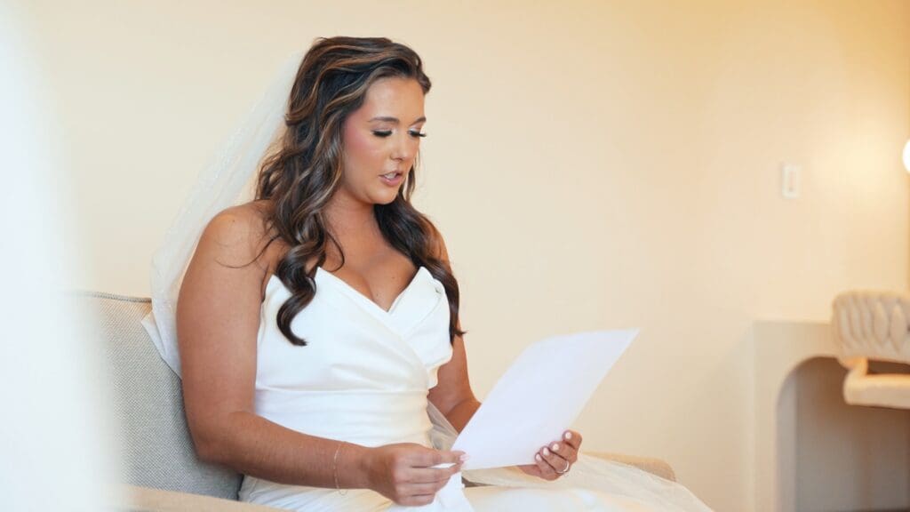 Bride reading a letter on her wedding morning during a quiet, emotional moment