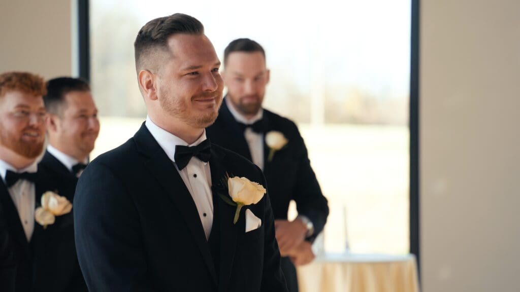 Groom reacting emotionally during the wedding ceremony as he listens