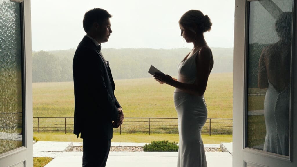 Bride reading private vows to the groom during a rainy wedding at Red Oak Valley