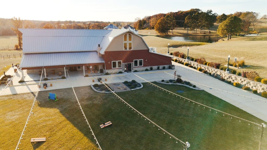 Aerial view of the Red Barn at Red Oak Valley surrounded by fall scenery