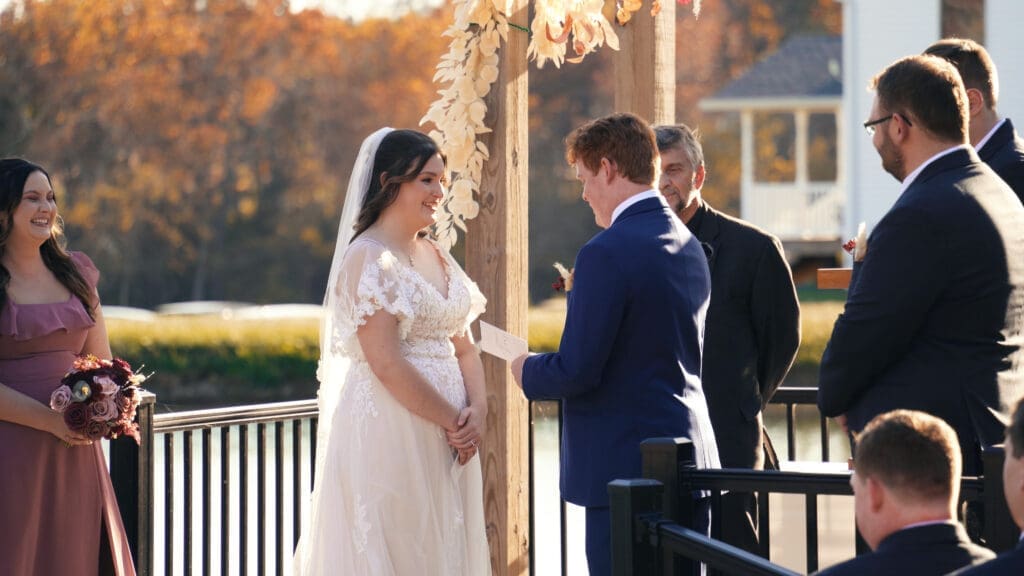 Lakeside wedding ceremony site at Red Oak Valley with a floral arbor overlooking the water