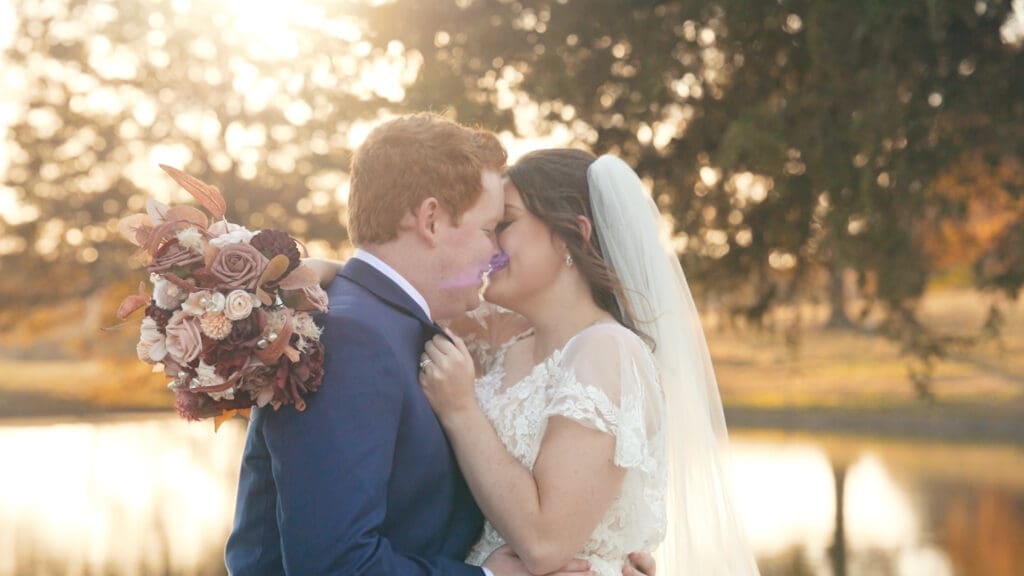Bride and groom exchanging vows during a lakeside wedding ceremony at Red Oak Valley